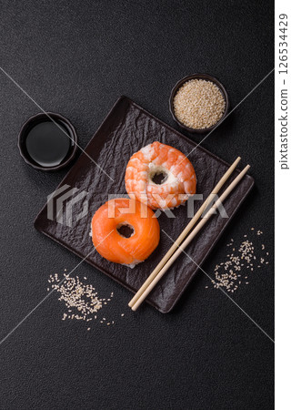 Donut shaped sushi rolls with salmon, shrimp and tuna 126534429