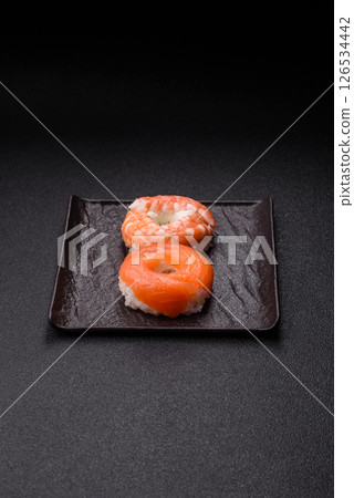 Donut shaped sushi rolls with salmon, shrimp and tuna Donut shaped sushi rolls with salmon, shrimp and tuna 126534442