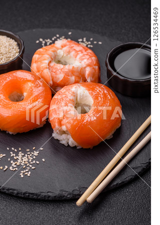 Donut shaped sushi rolls with salmon, shrimp and tuna Donut shaped sushi rolls with salmon, shrimp and tuna 126534469