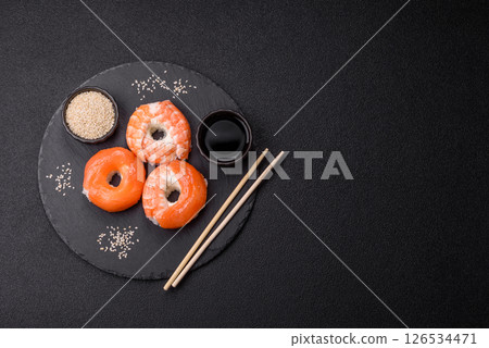 Donut shaped sushi rolls with salmon, shrimp and tuna Donut shaped sushi rolls with salmon, shrimp and tuna 126534471