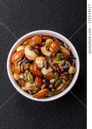 Honeyed cashew nuts, walnuts, hazelnuts, pine nuts and dried fruits 126534517