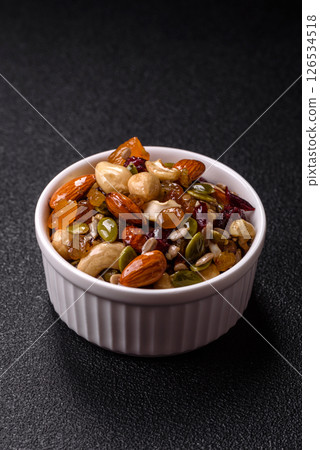 Honeyed cashew nuts, walnuts, hazelnuts, pine nuts and dried fruits 126534518