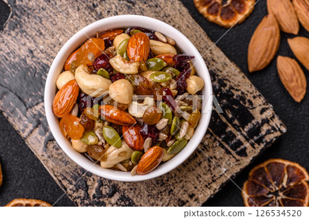 Honeyed cashew nuts, walnuts, hazelnuts, pine nuts and dried fruits 126534520