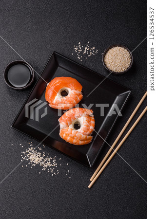 Donut shaped sushi rolls with salmon, shrimp and tuna 126534537