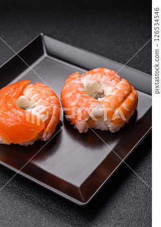 Donut shaped sushi rolls with salmon, shrimp and tuna Donut shaped sushi rolls with salmon, shrimp and tuna 126534546
