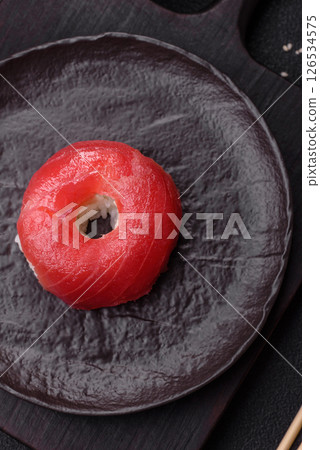 Donut shaped sushi rolls with salmon, shrimp and tuna Donut shaped sushi rolls with salmon, shrimp and tuna 126534575