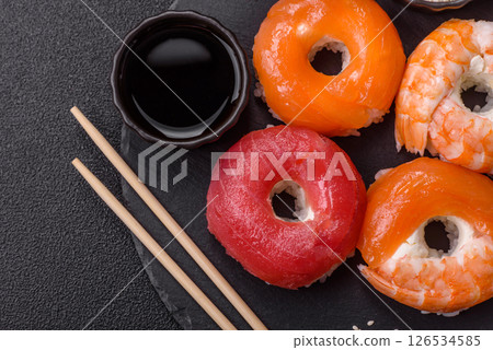 Donut shaped sushi rolls with salmon, shrimp and tuna Donut shaped sushi rolls with salmon, shrimp and tuna 126534585