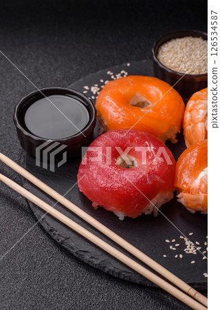 Donut shaped sushi rolls with salmon, shrimp and tuna 126534587