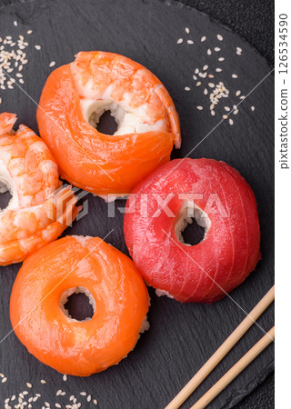 Donut shaped sushi rolls with salmon, shrimp and tuna Donut shaped sushi rolls with salmon, shrimp and tuna 126534590