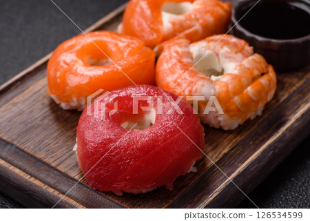 Donut shaped sushi rolls with salmon, shrimp and tuna 126534599