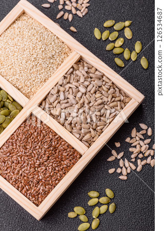 Sunflower, pumpkin, flax and sesame seeds in a wooden box Sunflower, pumpkin, flax and sesame seeds in a wooden box 126534687