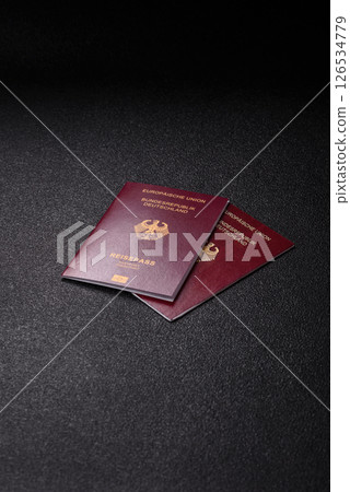 German citizen passport against the black textured background German citizen passport against the black textured background 126534779