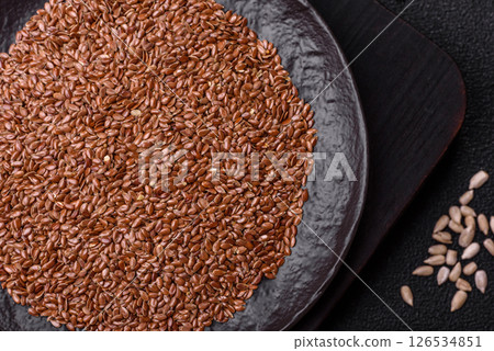 Flax seeds in a bowl, an ingredient for making vegan or vegetarian food Flax seeds in a bowl, an ingredient for making vegan or vegetarian food 126534851