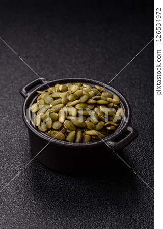 Peeled pumpkin seeds in a bowl, an ingredient for making vegetarian food Peeled pumpkin seeds in a bowl, an ingredient for making vegetarian food 126534972