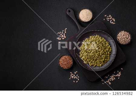 Peeled pumpkin seeds in a bowl, an ingredient for making vegetarian food Peeled pumpkin seeds in a bowl, an ingredient for making vegetarian food 126534982