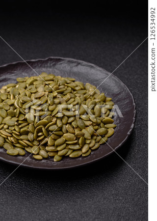 Peeled pumpkin seeds in a bowl, an ingredient for making vegetarian food 126534992