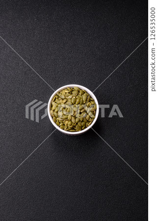 Peeled pumpkin seeds in a bowl, an ingredient for making vegetarian food Peeled pumpkin seeds in a bowl, an ingredient for making vegetarian food 126535000