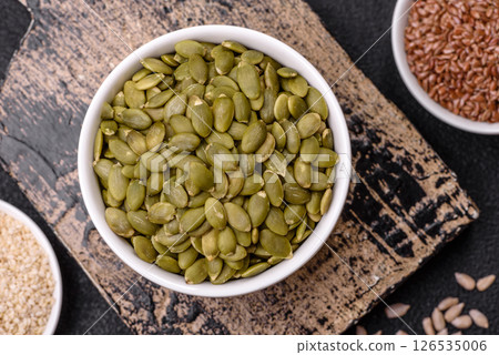 Peeled pumpkin seeds in a bowl, an ingredient for making vegetarian food Peeled pumpkin seeds in a bowl, an ingredient for making vegetarian food 126535006