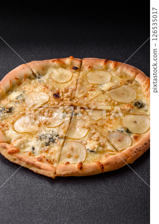 Delicious sweet pizza with pear, gorgonzola cheese and nuts 126535017