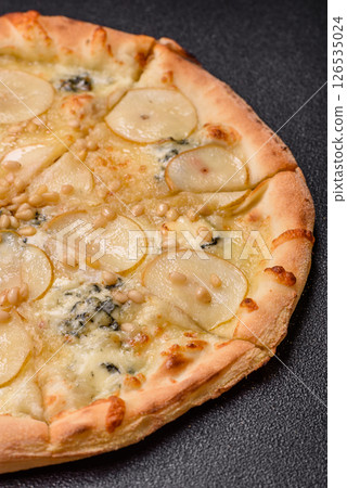 Delicious sweet pizza with pear, gorgonzola cheese and nuts Delicious sweet pizza with pear, gorgonzola cheese and nuts 126535024