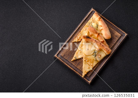 Delicious sweet pizza with pear, gorgonzola cheese and nuts Delicious sweet pizza with pear, gorgonzola cheese and nuts 126535031