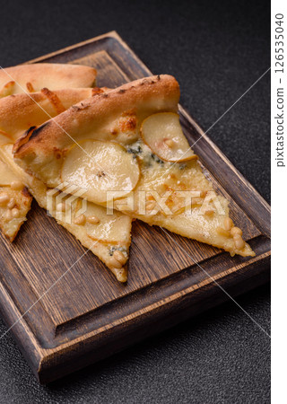 Delicious sweet pizza with pear, gorgonzola cheese and nuts Delicious sweet pizza with pear, gorgonzola cheese and nuts 126535040