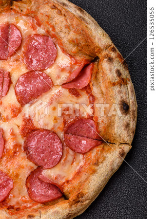 Pepperoni pizza with sausage, cheese, tomatoes, salt and spices 126535056