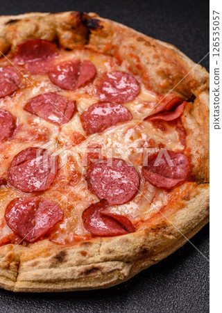 Pepperoni pizza with sausage, cheese, tomatoes, salt and spices 126535057