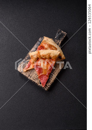Pepperoni pizza with sausage, cheese, tomatoes, salt and spices Pepperoni pizza with sausage, cheese, tomatoes, salt and spices 126535064