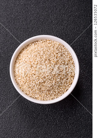 White sesame seeds in a bowl, an ingredient for making vegetarian food White sesame seeds in a bowl, an ingredient for making vegetarian food 126535072