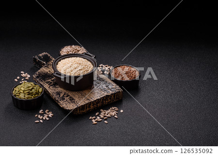 White sesame seeds in a bowl, an ingredient for making vegetarian food White sesame seeds in a bowl, an ingredient for making vegetarian food 126535092