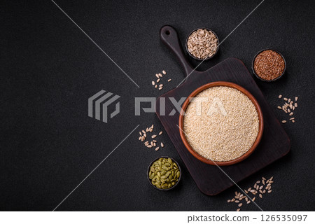 White sesame seeds in a bowl, an ingredient for making vegetarian food White sesame seeds in a bowl, an ingredient for making vegetarian food 126535097