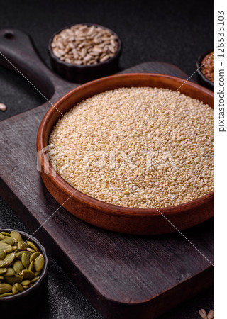 White sesame seeds in a bowl, an ingredient for making vegetarian food 126535103