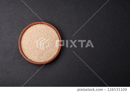 White sesame seeds in a bowl, an ingredient for making vegetarian food 126535109