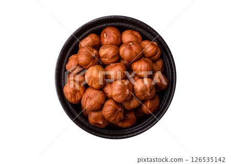 Raw hazelnuts without shells in a bowl 126535142