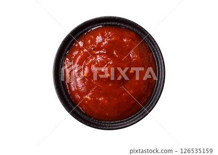 Red sauce or ketchup with salt and spices in ceramic sauce boat 126535159