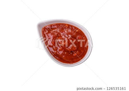 Red sauce or ketchup with salt and spices in ceramic sauce boat 126535161