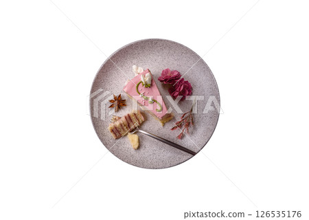 A piece of pink layered cake with strawberry flavor 126535176