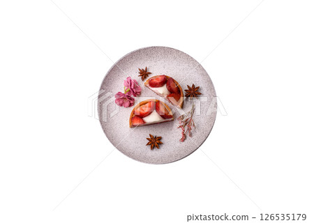 Round sweet tart with strawberry pieces and cream Round sweet tart with strawberry pieces and cream 126535179
