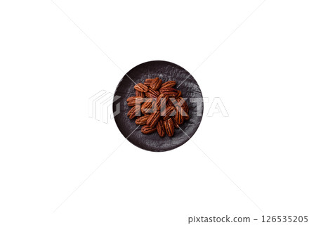 Nut, pecans in a ceramic bowl, an ingredient in vegan food 126535205