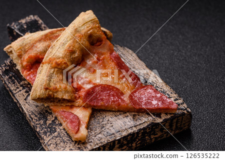Pepperoni pizza with sausage, cheese, tomatoes, salt and spices Pepperoni pizza with sausage, cheese, tomatoes, salt and spices 126535222