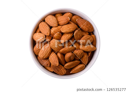 Roasted or raw peeled almonds in bowl Roasted or raw peeled almonds in bowl 126535277