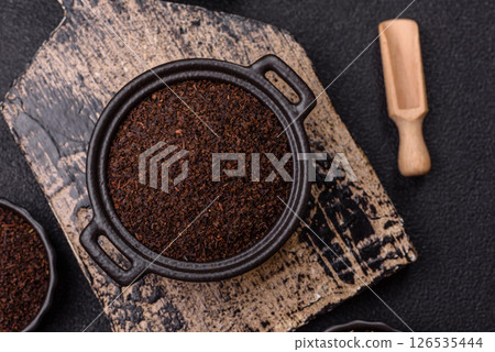 Black tea dry crushed in bowl 126535444