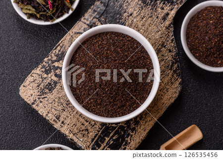 Black tea dry crushed in bowl 126535456