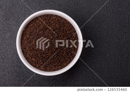 Black tea dry crushed in bowl 126535460