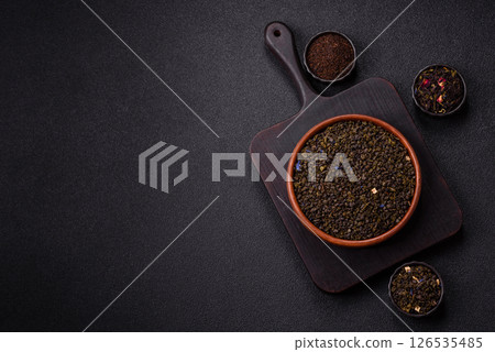 Dry green tea with soursop piece, knapweed petals in bowl Dry green tea with soursop piece, knapweed petals in bowl 126535485