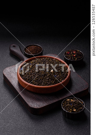 Dry green tea with soursop piece, knapweed petals in bowl Dry green tea with soursop piece, knapweed petals in bowl 126535487