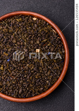 Dry green tea with soursop piece, knapweed petals in bowl Dry green tea with soursop piece, knapweed petals in bowl 126535494