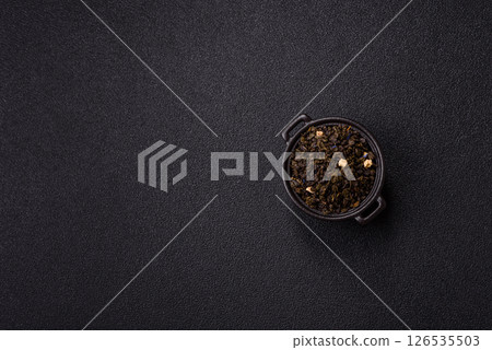 Dry green tea with soursop piece, knapweed petals in bowl Dry green tea with soursop piece, knapweed petals in bowl 126535503