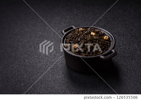 Dry green tea with soursop piece, knapweed petals in bowl 126535506